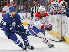 Owen Beck of the Montreal Canadiens flips the puck away against T.J. Brodie of the Toronto Maple Leafs during pre-season game at Scotiabank Arena on Sept. 28, 2022 in Toronto.