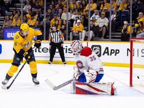 Predators' Cody Glass watches as a shot eludes Canadiens goalie Sam Montembeault Tuesday night in Nashville.