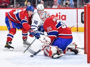 MONTREAL, CANADA - JANUARY 21:  Canadiens' Jordan Harris (54) challenges Mitchell Marner (16) of the Toronto Maple Leafs as goaltender Sam Montembeault makes a save during the first period at the Bell Centre on Saturday, Jan. 21, 2023, in Montreal.