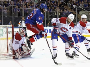 Mika Zibanejad (93) of the New York Rangers jumps in front of Canadiens goaltender Sam Montembeault during the second period at Madison Square Garden on Sunday, Jan. 15, 2023, in New York City.