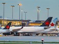 Air Canada jets of various sizes parked at the terminal at Montreal's Trudeau Airport on Nov. 17, 2021.