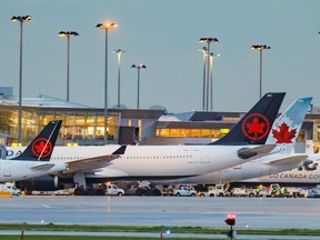 Air Canada jets of various sizes parked at the terminal at Montreal's Trudeau airport in 2021.