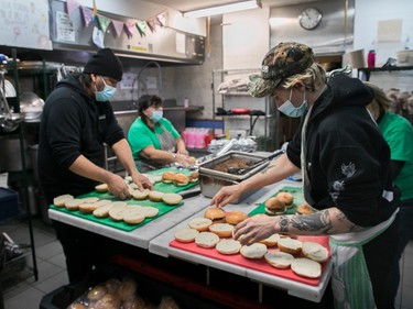 Workers and volunteers prepare a meal at Resilience Montreal, Monday, December 12, 2022.