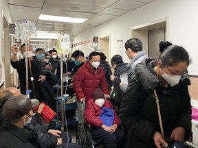 Patients receive IV drip treatment in a hallway in the emergency department of a hospital, amid the coronavirus disease (COVID-19) outbreak in Shanghai, China January 4, 2023. REUTERS/Staff