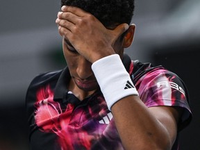 Canada's Felix Auger-Aliassime reacts as he plays against Czech Republic's Jiri Lehecka during their men's singles match on day seven of the Australian Open tennis tournament in Melbourne on January 22, 2023. (Photo by Paul CROCK / AFP) / -- IMAGE RESTRICTED TO EDITORIAL USE - STRICTLY NO COMMERCIAL USE --