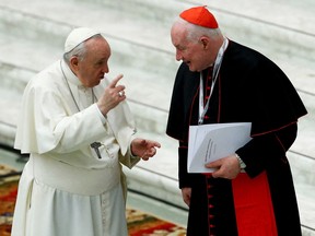 Pope Francis (left) talks to Cardinal Marc Ouellet at the Vatican Feb. 17, 2022.