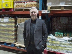 Welcome Hall Mission CEO Sam Watts poses next to pallets of food in the warehouse of the food bank in Montreal, Tuesday, March 14, 2017.