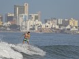 A man surfs on Pinitos beach, in Mazatlan, Mexico, Tuesday, Oct. 12, 2021. The Canadian government says 1.8 million residents travelled to Mexico in 2022. Some of the more popular tourist spots include Cabo San Lucas, Cancun, Mazatlan, Playa Del Carman and Puerto Vallarta.
