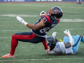 Montreal Alouettes fullback Régis Cibasu is brought down by Toronto Argonauts' Jamal Peters during the first half at Molson Stadium in Montreal on Oct. 22, 2022.