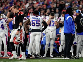 FILE PHOTO: Jan 2, 2023; Cincinnati, Ohio, USA; The Buffalo Bills gather as an ambulance parks on the field while CPR is administered to Buffalo Bills safety Damar Hamlin (3) after a play in the first quarter of the NFL Week 17 game between the Cincinnati Bengals and the Buffalo Bills at Paycor Stadium in Downtown Cincinnati. The game was suspended with suspended in the first quarter after Buffalo Bills safety Damar Hamlin (3) was taken away in an ambulance following a play. Mandatory Credit: Sam Greene-USA TODAY Sports/File Photo