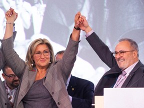 Magali Picard has her hands raised by outgoing Fédération des travailleurs et travailleuses du Québec (FTQ) president Daniel Boyer, right, during a ceremony announcing her as the new president of the union in Montreal on Thurs., Jan. 19, 2023.
