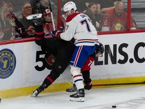 Canadiens' Kirby Dach collides with Senators defenceman Thomas Chabot along the boards during second period on Jan. 28, 2023, in Ottawa.