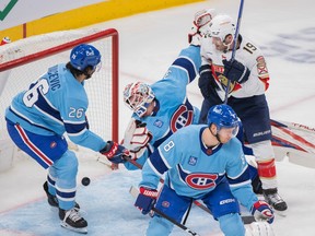 Montreal Canadiens' Johnathan Kovacevic, left, and Mike Matheson defend against Florida Panthers' Matthew Tkachuk as Sam Reinhart (not shown) scores on Sam Montembeault during second period in Montreal on Jan. 19, 2023.
