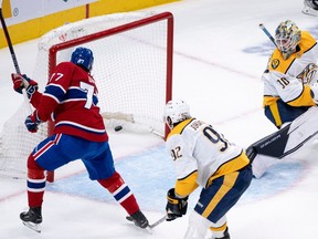 Montreal Canadiens' Kirby Dach scores past Nashville Predators goaltender Yaroslav Askarov as Ryan Johansen looks on during first period in Montreal on Jan. 12, 2023.