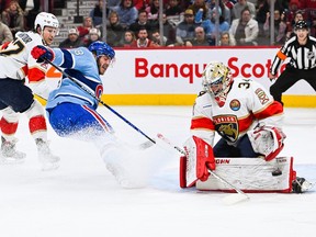 Florida Panthers goalie Alex Lyon (34) makes a save over Montreal Canadiens left wing Mike Hoffman (68) during the first period at Bell Centre in Montreal on Jan. 19, 2023.