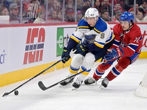 St. Louis Blues forward Tyler Pitlick (9) plays the puck against Canadiens' Arber Xhekaj (72) during the first period at the Bell Centre in Montreal on Saturday, Jan. 7, 2023.
