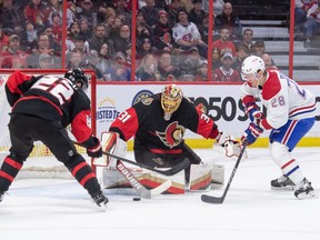 Senators goalie Anton Forsberg makes a save in front of Canadiens' Christian Dvorak (28) in the second period at the Canadian Tire Centre in Ottawa on Saturday, Jan. 28, 2023.