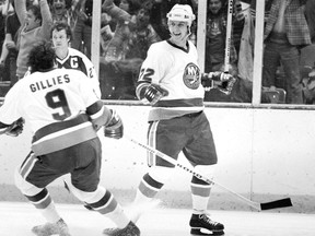 Mike Bossy, right, of the New York Islanders, celebrates after he scored the winning goal in overtime to beat the Toronto Maple Leafs 3-1 at the Nassau Coliseum in Uniondale, N.Y., on April 20, 1978. At left are Clark Gillies of the Islanders and the Maple Leafs' captain Darryl Sittler.