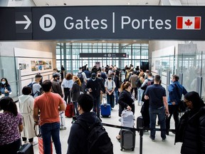 Travellers crowd the security queue in the departures lounge at Toronto Pearson International Airport in Mississauga, Ont., in May 2022.
