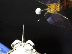 In this photo made available by NASA, the space shuttle Challenger launches the Earth Radiation Budget Satellite in 1984. On Friday, Jan. 6, 2023, the U.S. space agency said the 38-year-old NASA satellite is about to fall from the sky, but the chance of wreckage falling on anybody is "very low." It's expected to come down Sunday night, give or take 17 hours. (NASA via AP)