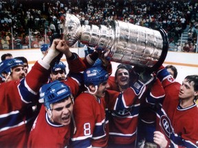 Montreal Canadiens players hoist the Stanley Cup on the ice of the Saddledome after defeating the Calgary Flames 4-3 in Game 5 of the Stanley Cup Final on May 24, 1986.