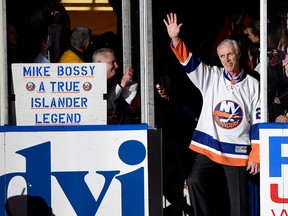 Hockey Hall of Famer and former New York Islander Mike Bossy waves to fans as he is introduced before a game between the Islanders and the Boston Bruins at Nassau Coliseum on Jan. 29, 2015, in Uniondale, N.Y.