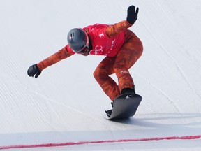 Canada's Eliot Grondin crosses the finish line in the men's snowboard cross semifinals at the 2022 Beijing Winter Olympics in Zhangjiakou, China on Thursday, February 10, 2022.