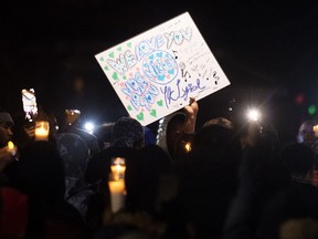 People attend a vigil in memory of Nicous D'Andre Spring in Montreal, Friday, Dec. 30, 2022. Spring died in hospital after reportedly suffering injuries on Saturday, Dec. 24, at the Bordeaux provincial jail.
