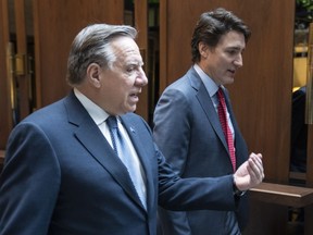 Prime Minister Justin Trudeau and Quebec Premier Francois Legault chat while walking to a meeting in Montreal, on Tuesday, December 20, 2022.