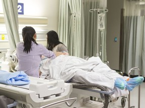 Members of a medical team care for a patient at Toronto's Sunnybrook Hospital on Tuesday, May 1, 2018. A preliminary investigation into why more than 50 per cent of candidates failed Quebec's nurse licencing exam last fall has found "concerning elements" surrounding both the exam and student preparation.