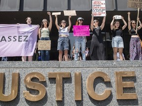 People take part in a protest against a decision by a judge in the case against a man who pled guilty to sexual assault and voyeurism in Montreal, Sunday, July 10, 2022.