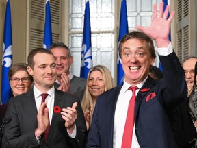 Liberal Party president Rafael Primeau Ferraro, left, applauds interim leader Marc Tanguay in November. Ferraro noted that the last leadership race was held in the middle of the previous mandate, and "we're in no rush" to find a leader to replace Dominique Anglade.