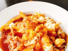 According to @Canada, this shredded cheese monstrosity is poutine.