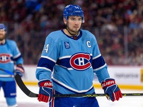 Montreal Canadiens centre Nick Suzuki lines up for a faceoff during third period against the Seattle Kraken in Montreal on Jan. 9, 2023.