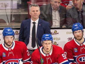 Montreal Canadiens head coach Martin St. Louis stands behind Jonathan Drouin, left, Jesse Ylonen and Joel Armia during a game against the Nashville Predators at the Bell Centre on Thursday January 12, 2023.