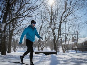 Francois-Xavier Teysseire practices his ski stride without poles in the fresh snow and the warmth (brrr) of the January sun, at Lafontaine park Jan. 31, 2023.