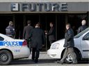 Montreal police investigators enter Future Electronics in Pointe-Claire on Nov. 4, 2009.