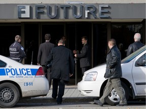 Montreal police investigators enter  Future Electronics in Pointe-Claire on Nov. 4, 2009.