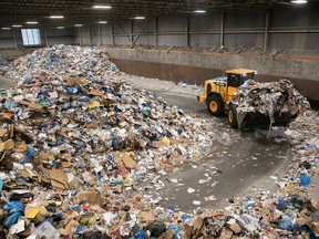 Heavy machinery is used to move materials at the recycling centre in Lachine on Thursday, Feb. 2, 2023.