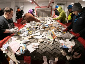 Workers sort recyclable products at the Lachine facility, where the purity of plastic, metal, glass and cardboard is now close to 100 per cent, according to contract holder Société VIA.