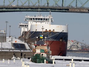A converted tug boat is ice-locked in the Old Port as a two large ships sit empty, Feb. 6, 2023.