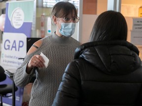 Administrative agent Brenda Klinkow, left, greets a patient at the welcome kiosk at Santa Cabrini Hospital's emergency department on Wednesday February 8, 2023.