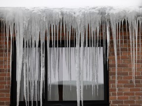Icicles hang from a residential building in Montreal, on Tuesday, Feb. 7, 2023.