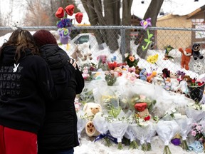 Two women comfort each other as they visit the site of the fatal bus crash at Garderie Éducative Ste-Rose in Laval on  Feb. 9, 2023.