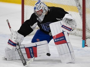 Laval Rocket's Cayden Primeau makes a save during practice at Place Bell in Laval on Feb. 9, 2023.