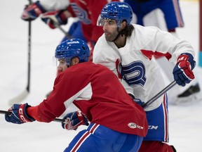 Tory Dello, right, and Peter Abbandonato battle during Rocket practice at Place Bell in Laval on Feb. 9, 2023.
