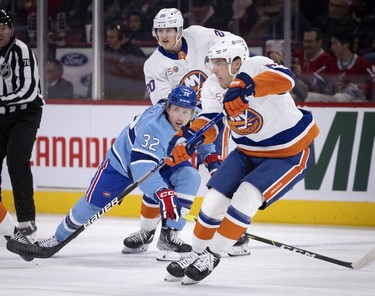 Montreal Canadiens centre Rem Pitlick (32) gets caught up in traffic during first-period action against the New York Islanders in Montreal on Saturday, Feb. 11, 2023.