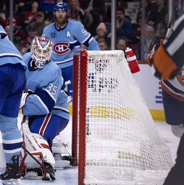 Montreal Canadiens goaltender Sam Montembeault (35) looks back at the referee for the call after the puck slightly crossed the line to give the New York Islanders their second goal during 2nd-period action in Montreal on Saturday, Feb. 11, 2023.
