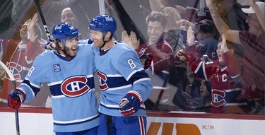 Montreal Canadiens left wing Mike Hoffman (68) and Montreal Canadiens defenceman Mike Matheson (8) celebrate Matheson’s overtime goal to beat the New York Islanders 4-3 in Montreal on Saturday, Feb. 11, 2023.