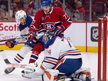 Edmonton Oilers defenceman Vincent Desharnais (73) squeezes Canadiens centre Kirby Dach (77) as he pressures Oilers goaltender Stuart Skinner in Montreal on Sunday, Feb. 12, 2023.